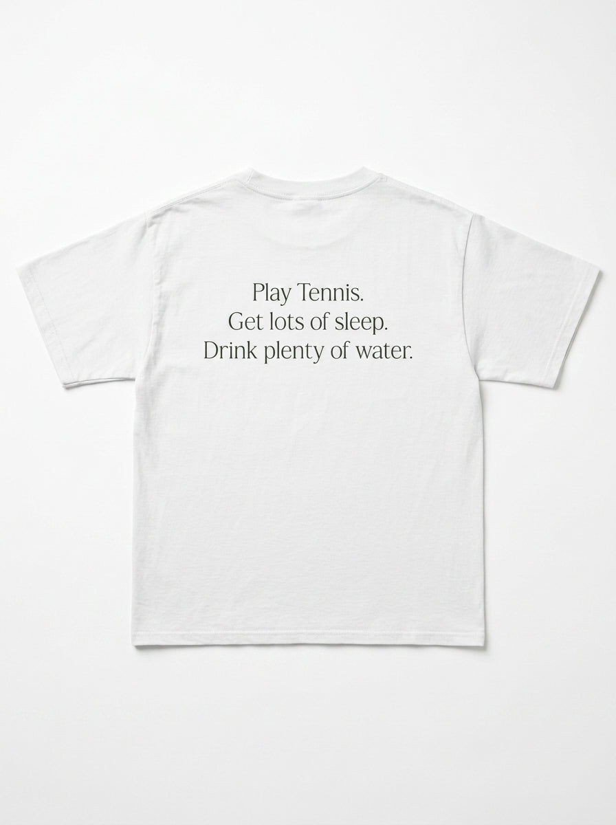 A white short-sleeve t-shirt shown from the back, featuring the printed text 'Play Tennis. Get lots of sleep.